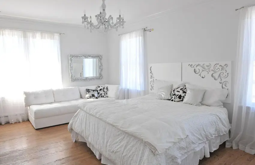 Eclectic bedroom, white furnishings and lighting fixtures