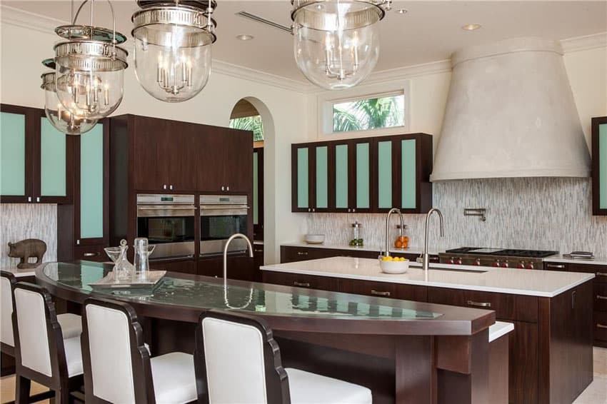 Eclectic kitchen with curved breakfast bar and custom range hood