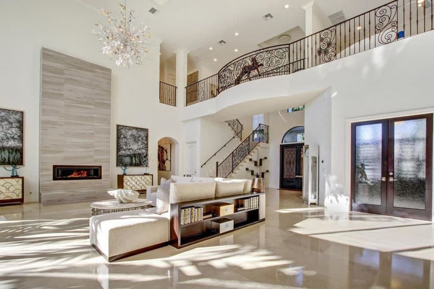 elegant living room with high ceiling chandelier and modern fireplace