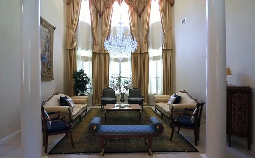 Formal living room with pillars, high ceiling and crystal chandelier