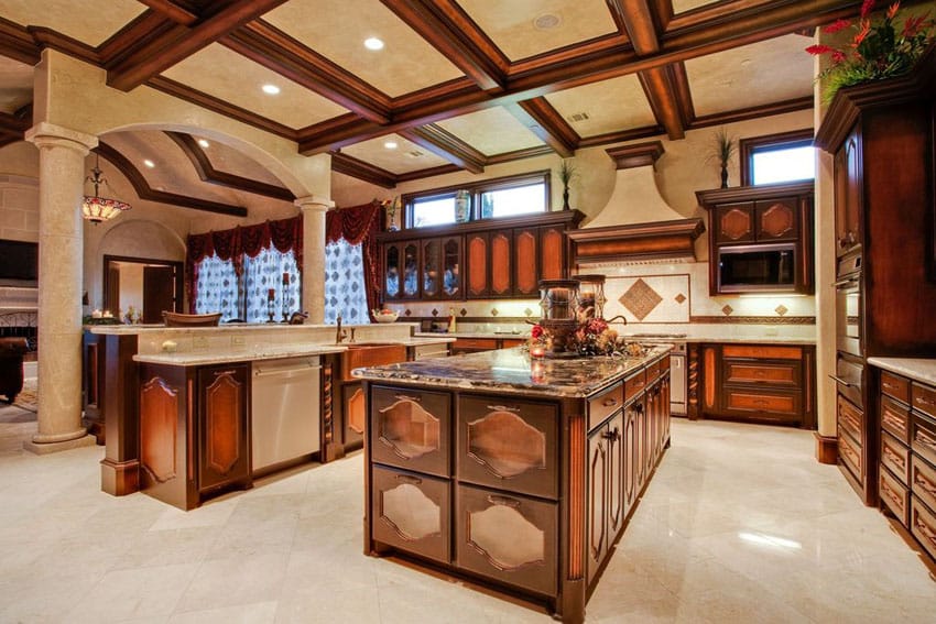 High end kitchen with pillars dual islands, azurite granite counters, box ceiling and marble tile floors