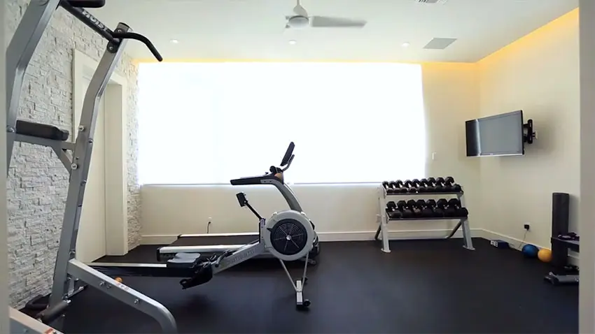 Home gym workout room with exercise machines and mat floors