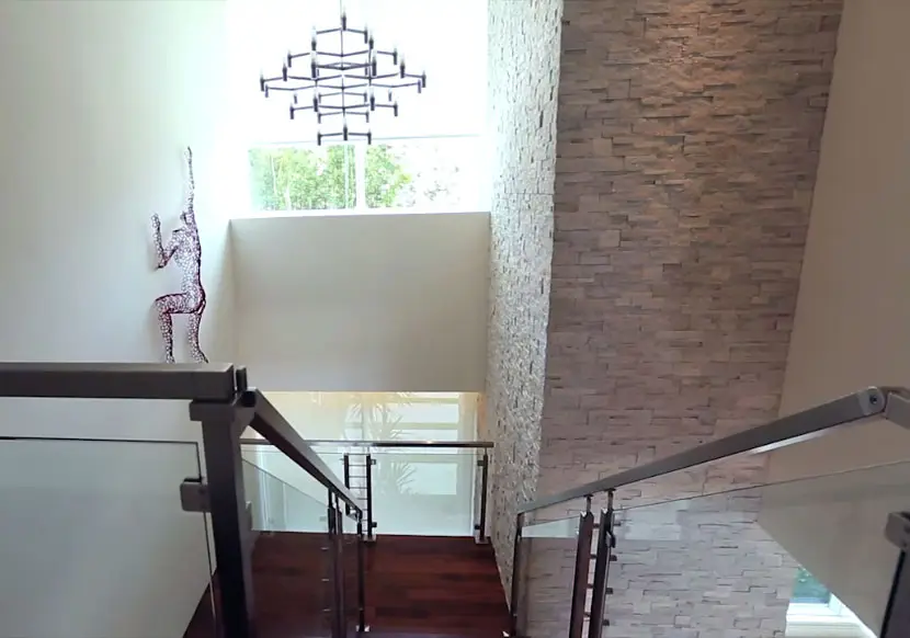 Interior design modern home with climbing man wall art and custom chandelier