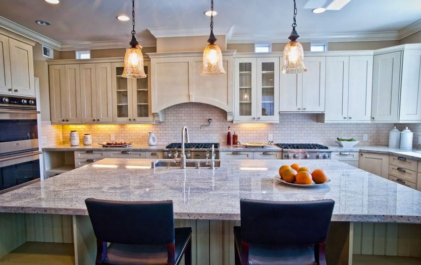 Kitchen with large island with bianco catalina granite and seating