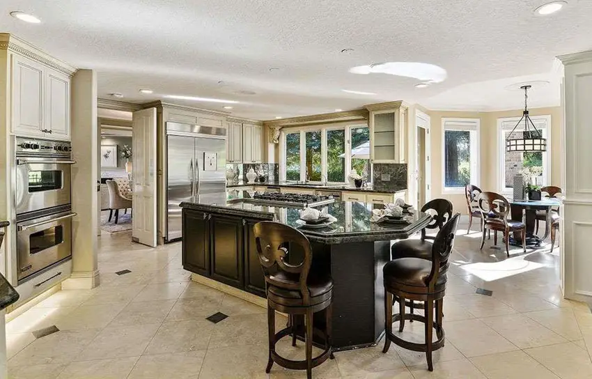Kitchen with unusually shaped island with breakfast bar dining and vienna swivel counter stools
