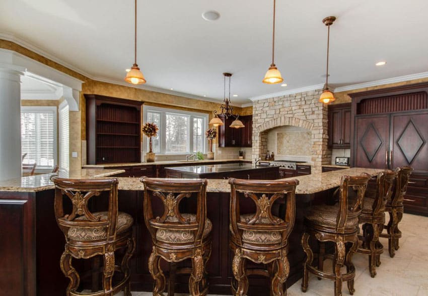 Kitchen with long dining island with bar stools and space for cooking