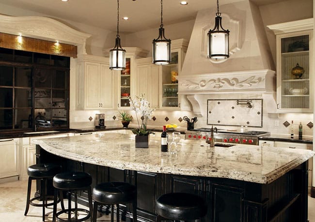 Luxury kitchen island with snowfall granite counters and dark under cabinet
