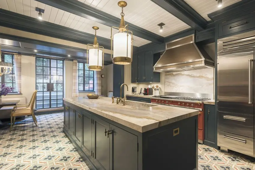 Luxury kitchen with black cabinets, beige marble counters and exposed beams ceiling