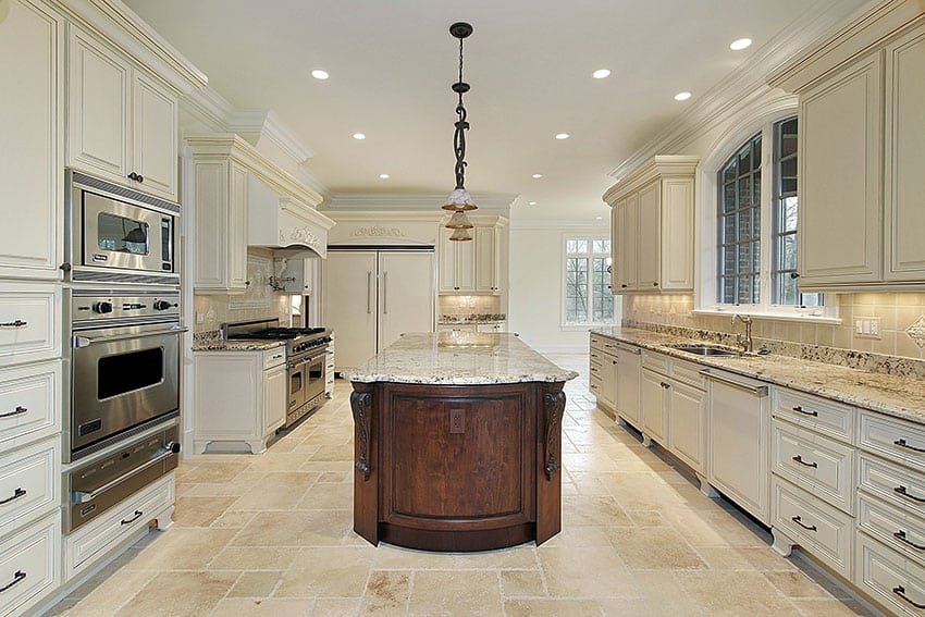 Luxury kitchen with antique white cabinets and brown island with beige granite