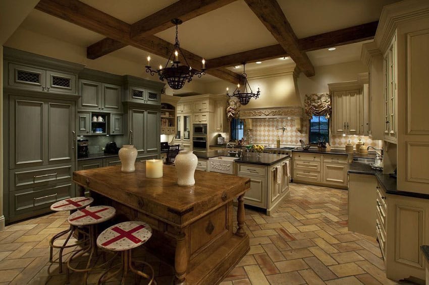 Luxury French antique kitchen with reclaimed pine island and cooking island with herringbone terracotta flooring