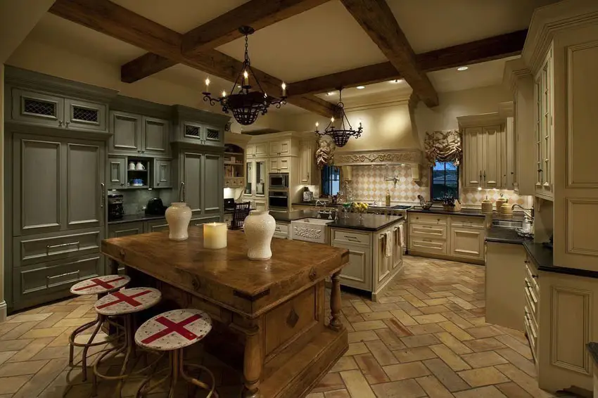 Luxury French kitchen with reclaimed pine island with terracotta flooring