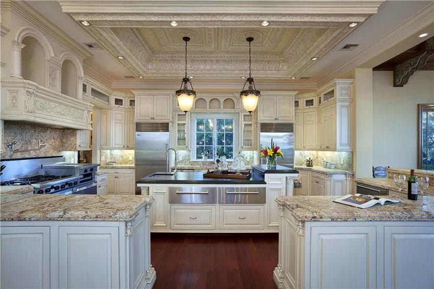 Luxury traditional cream color cabinet kitchen with peninsula and island with granite counter