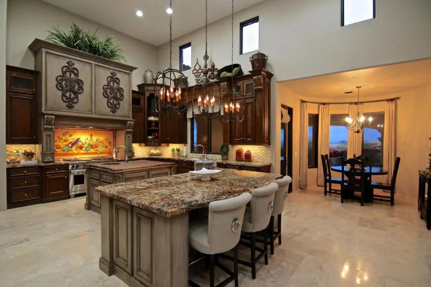 Mediterranean kitchen with butcher block island and breakfast bar island with granite counter