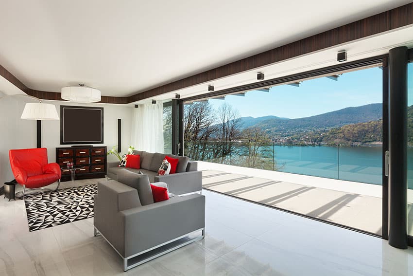 Modern lake view living room with red and gray furniture