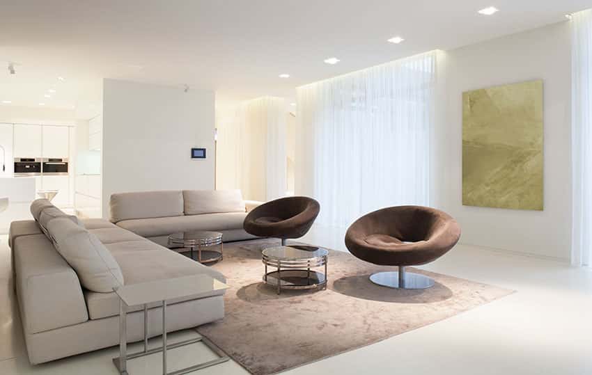 Modern living room with cream sofas and brown barrel chairs