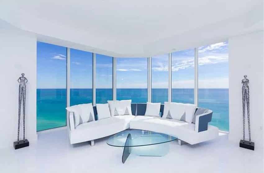 Modern white living room with expansive oceanfront view