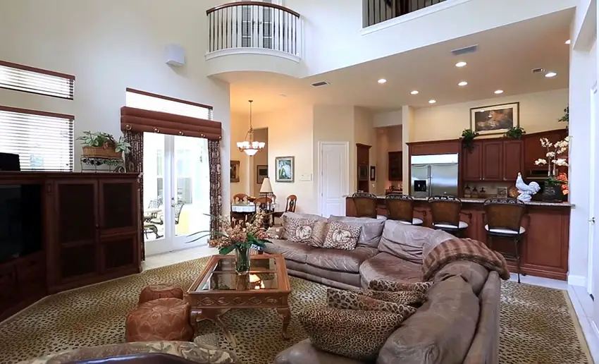 Open living room with high ceiling and upstairs balcony