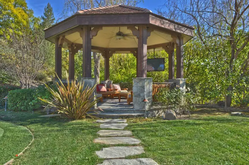 Pathway leading to large gazebo with outdoor lounge furniture