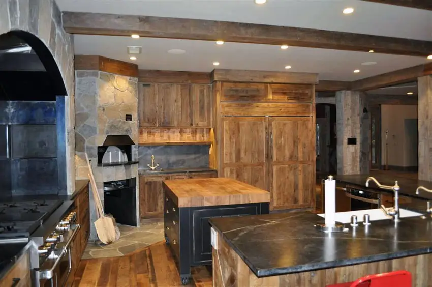 Rustic kitchen with stone oven, solid wood cabinets and soapstone counters