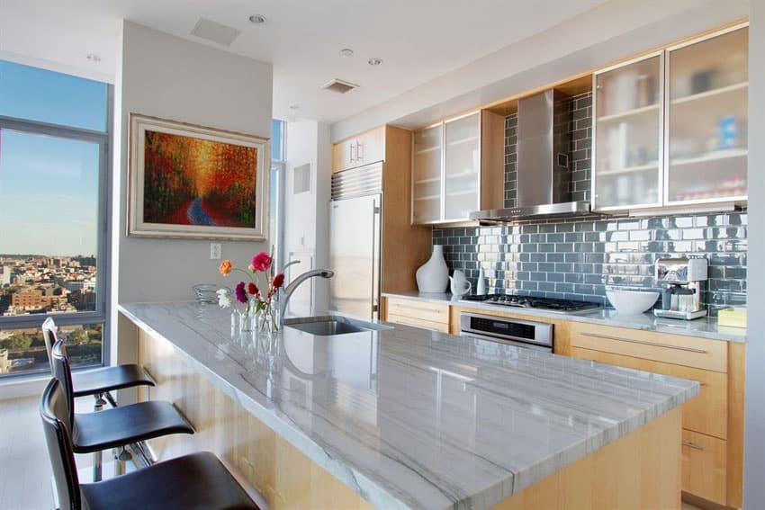 Small contemporary apartment kitchen with marmara white marble counter and breakfast bar peninsula