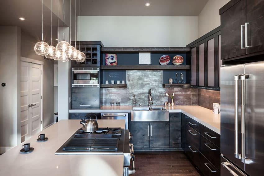 Small contemporary kitchen with dark cabinets light countertops and porcelain tile backsplash