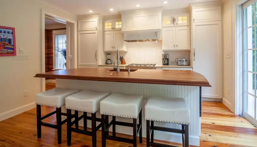 Small cottage style kitchen with large butcher block island