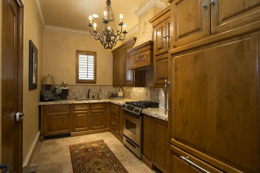 Small Mediterranean kitchen with new venetian gold granite counter and travertine floors