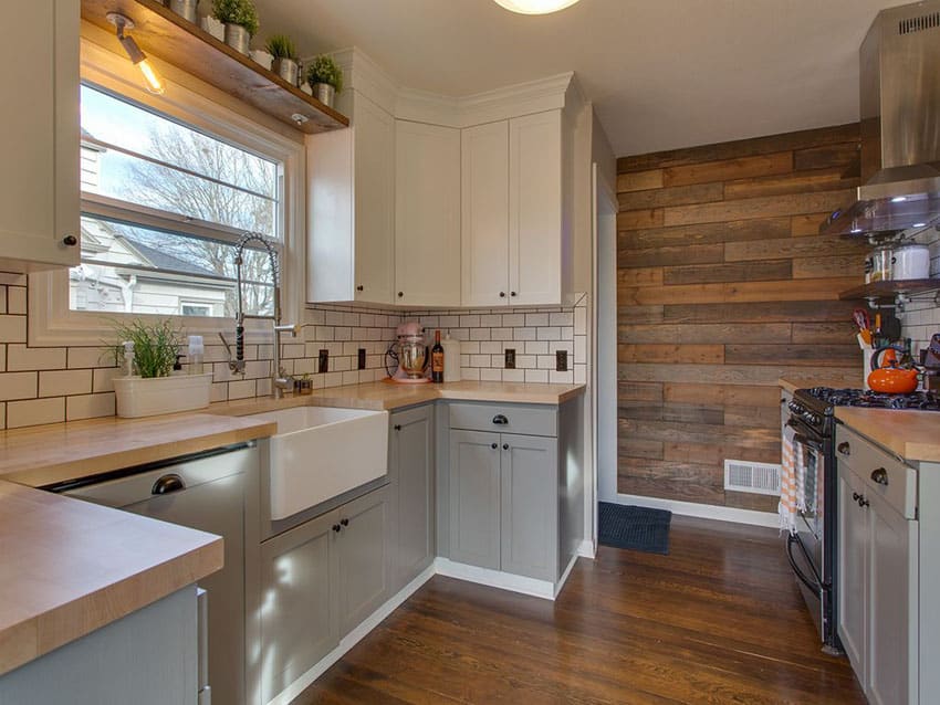 Small u shaped country kitchen with reclaimed wood accent wall and subway tile backsplash