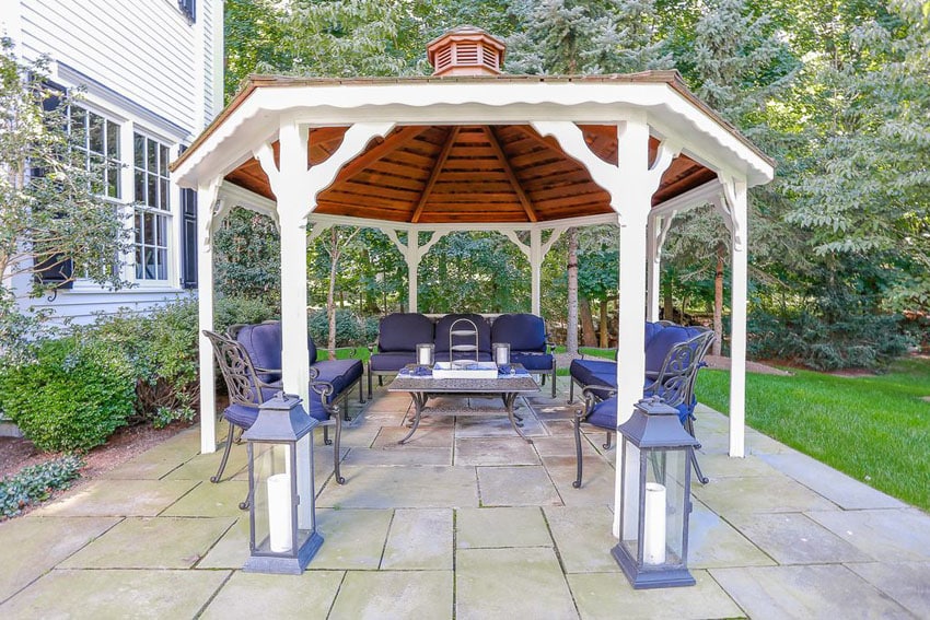 Stone patio with wood gazebo and outdoor furniture