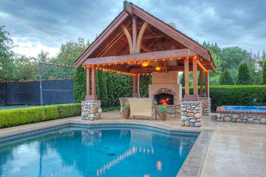 Swimming pool gazebo with outdoor fireplace and river rock pillar design