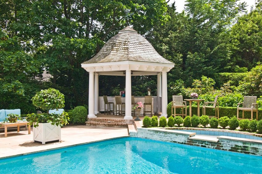 Swimming pool with gazebo with bar area and bar stools