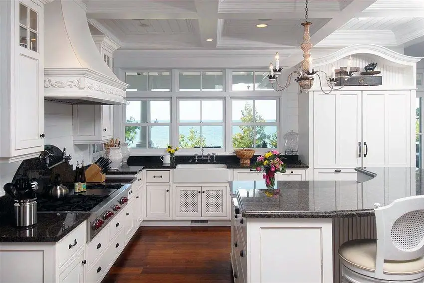 Traditional kitchen with angola black granite counters, curved breakfast bar island, chandelier and ocean views