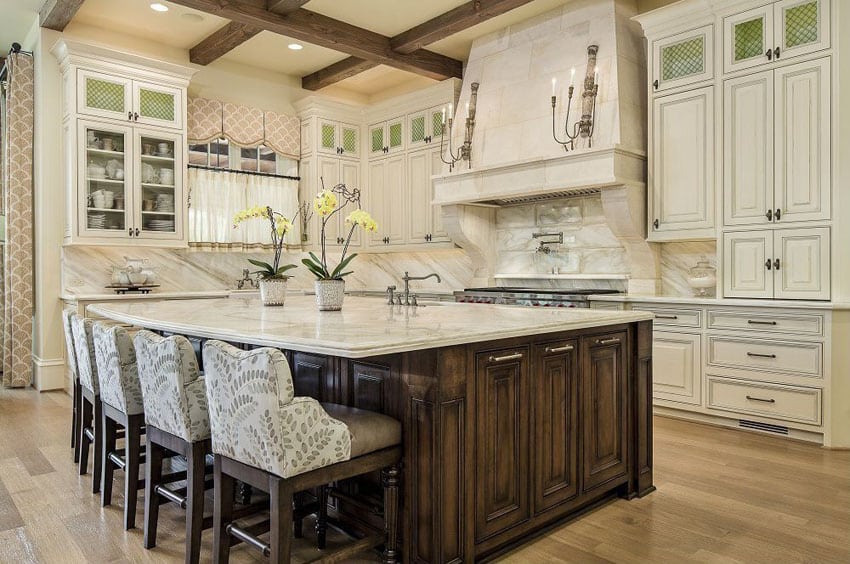 Traditional kitchen with bianco carrara marble and breakfast bar island with counter stools