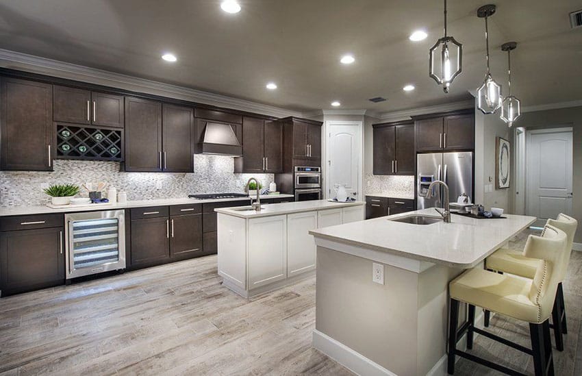 Traditional L shape kitchen with dark cabinets, two islands and wood style porcelain tile flooring