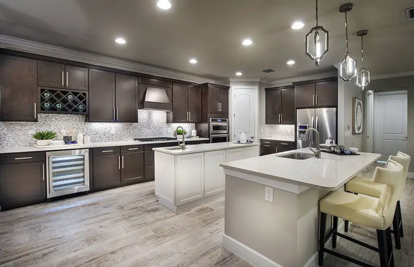 Traditional L shape kitchen with dark cabinets and porcelain tile flooring
