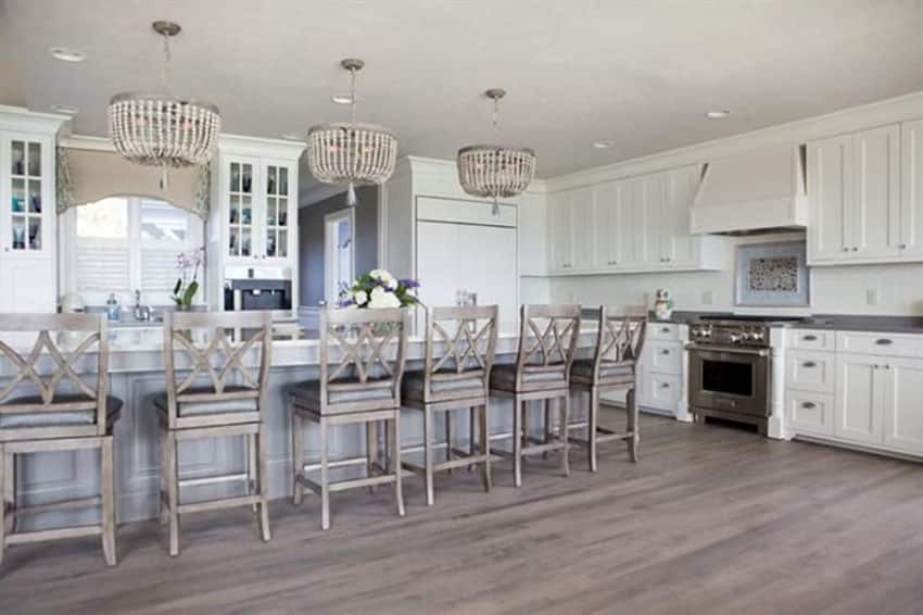 Traditional kitchen with long island with swivel bar stools with leather cushions