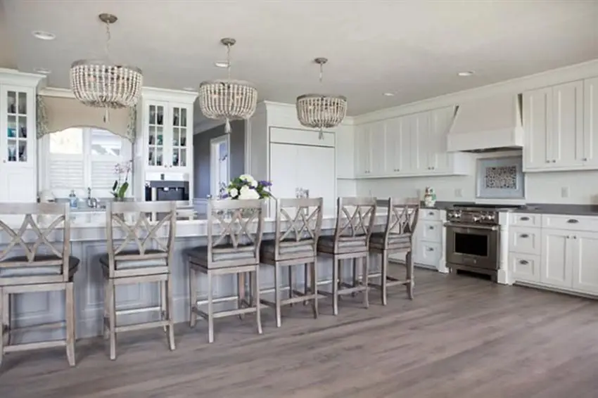 Traditional kitchen with long island with swivel bar stools with leather cushions