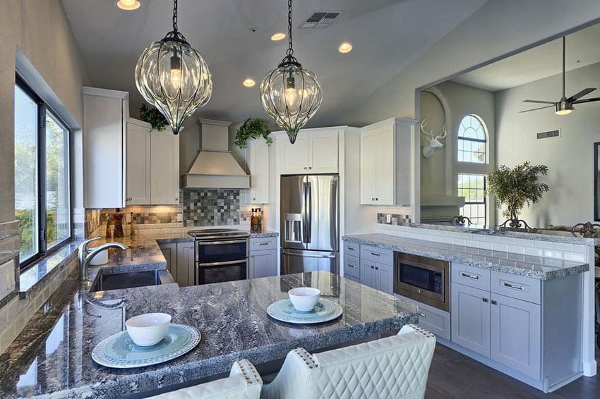 kitchen with monte cristo granite, fabric chairs and subway tile backsplash