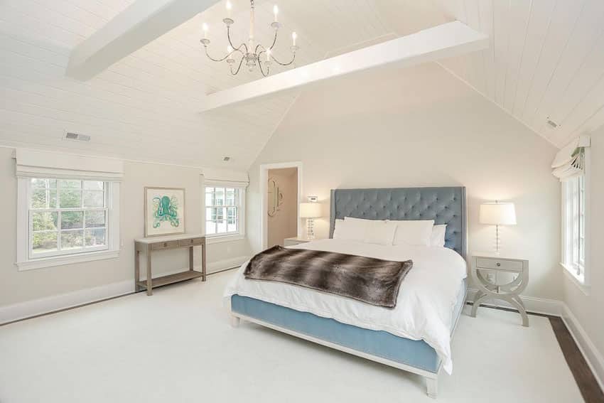 Bedroom with blue tufted headboard 