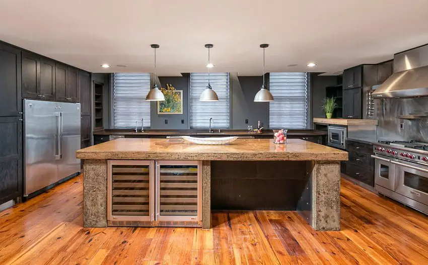 Transitional kitchen with black cabinets, concrete counter island, wood floors and high end appliances