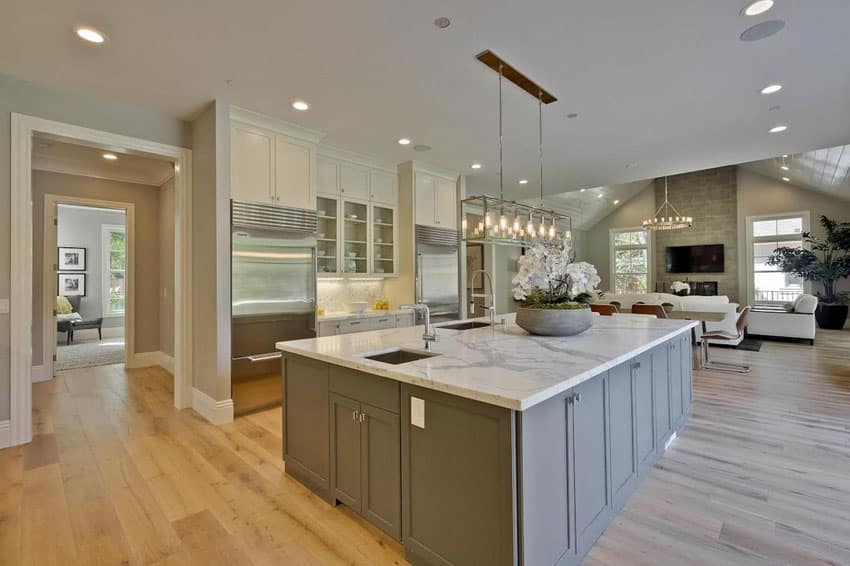 Kitchen with white oak wood floors and two types of color cabinets