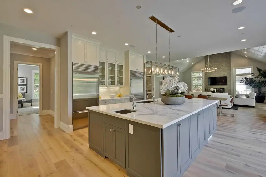 Transitional kitchen with carrara white marble counter island, white oak wood floors and two color cabinets