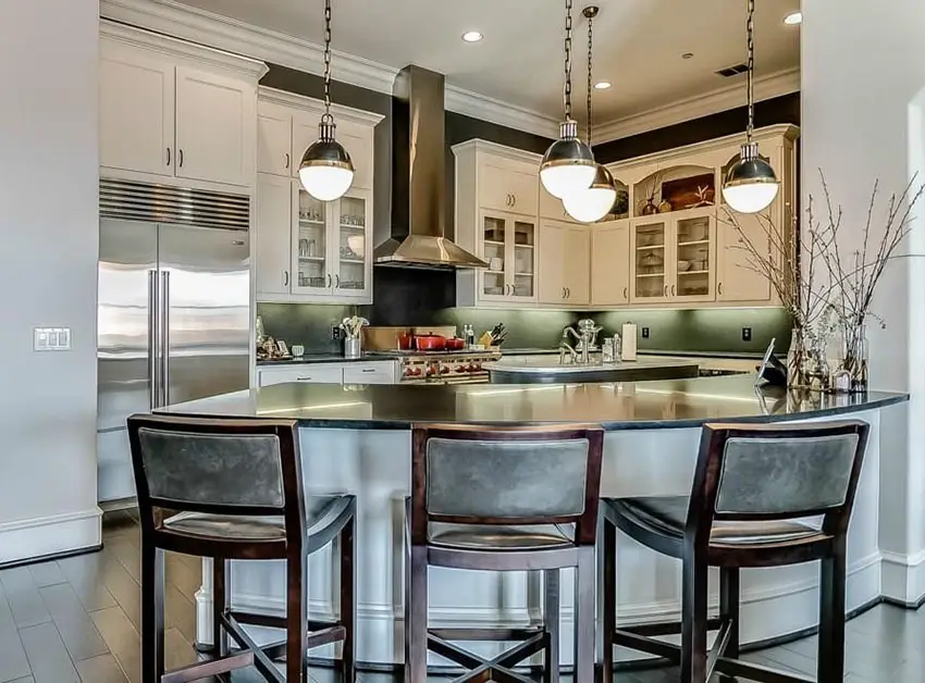 Transitional kitchen with curved peninsula and black granite counter
