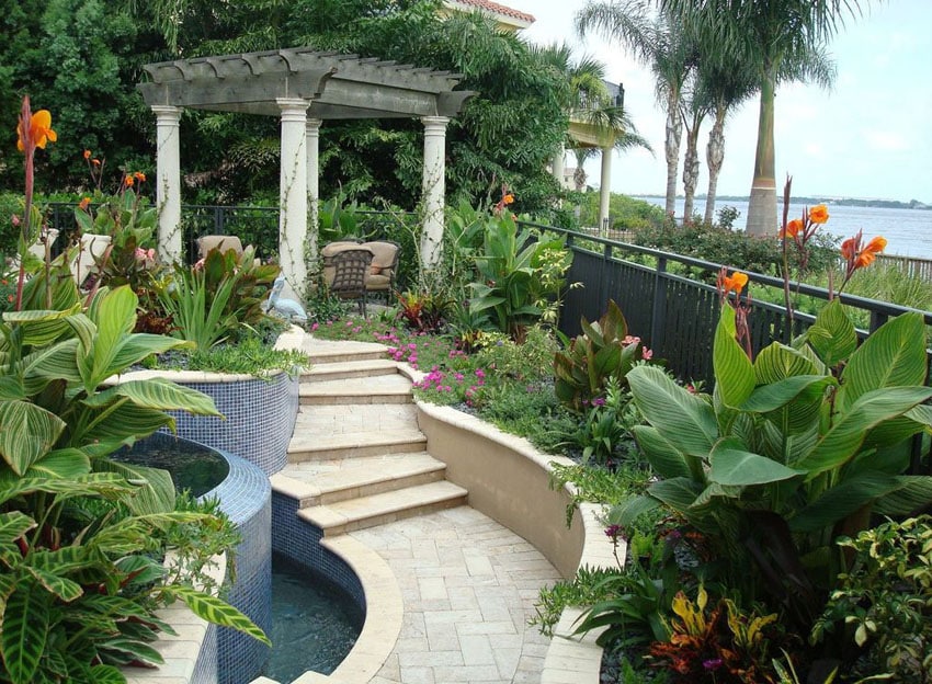 Tropical landscaped garden with path to pillar pergola