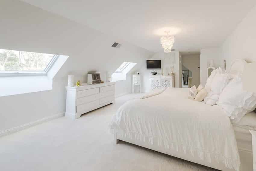 Upstairs attic bedroom with white color theme and drum chandelier