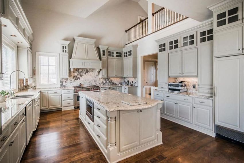 White cabinet kitchen with alpine white granite counter and backsplash open to second story balcony
