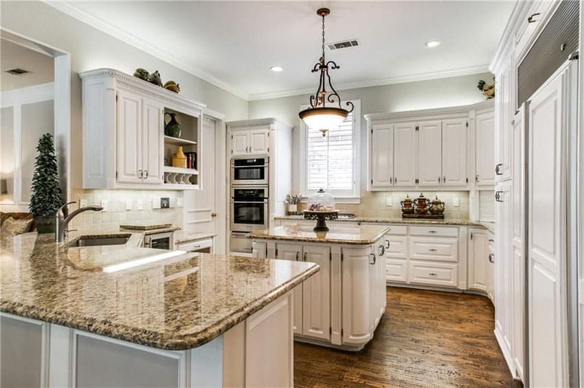 white cabinet kitchen with boreal granite counters and peninsula and island