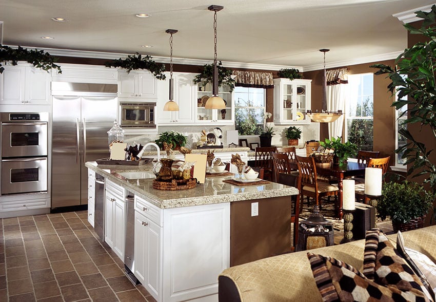 White cabinet kitchen with transitional design, brown color theme and light beige granite island