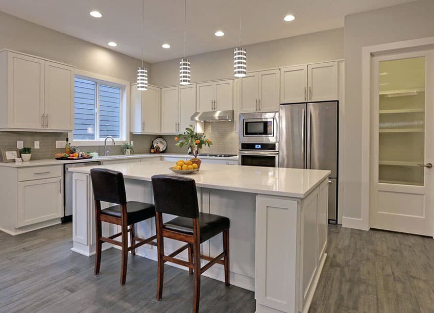 White contemporary kitchen with quartz countertop island and off white painted walls