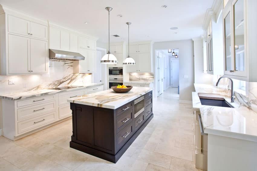 White transitional kitchen with brown cabinet island, calacatta gold marble counters and classic pendant lights